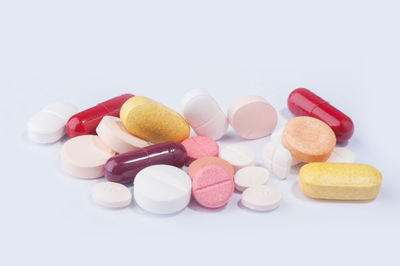 Multi colored capsules over white background