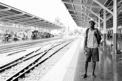 Man standing on railroad station platform