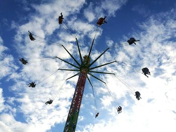 Low angle view of birds flying against sky