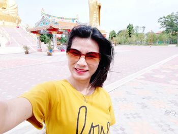 Portrait of woman standing outside temple