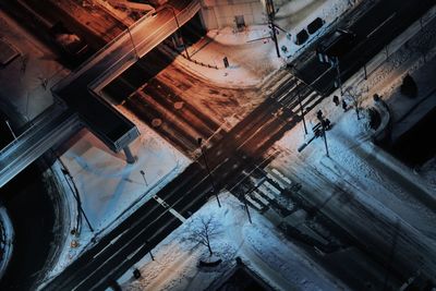 High angle view of snow covered road in city at night