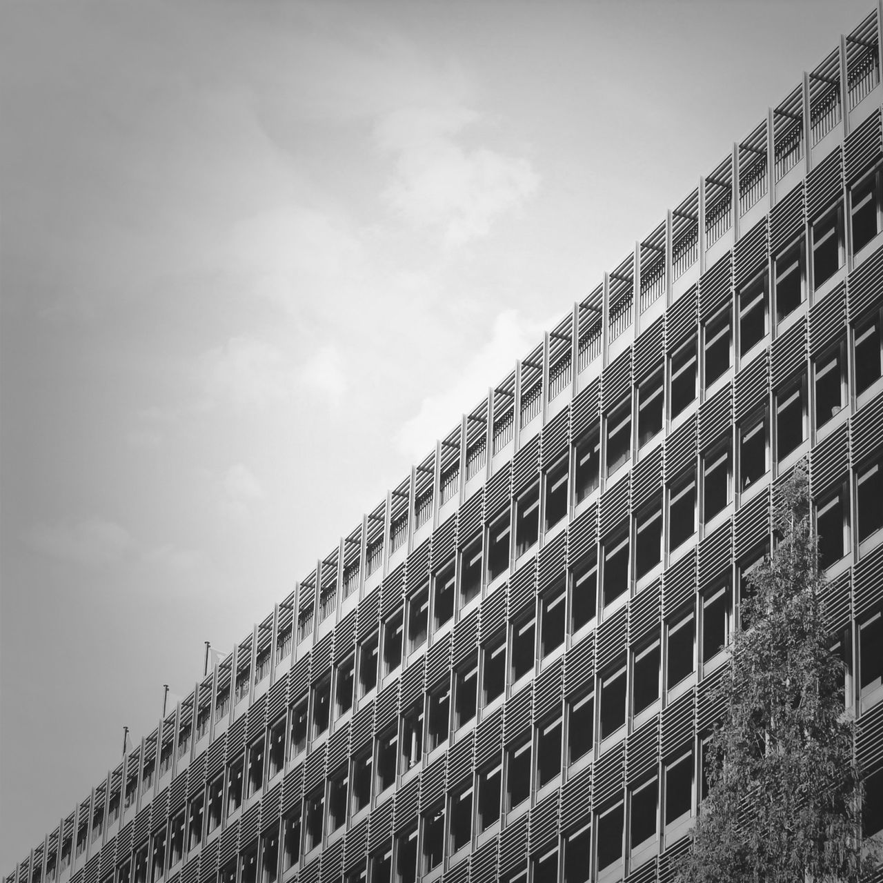 architecture, built structure, building exterior, low angle view, sky, building, day, city, history, outdoors, window, in a row, no people, travel destinations, cloud - sky, residential building, pattern, architectural feature, repetition, famous place