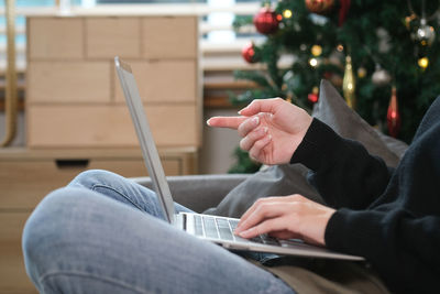 Midsection of man using digital tablet