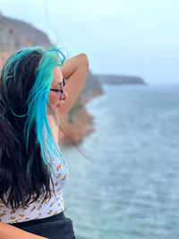 Rear view of woman looking away at beach