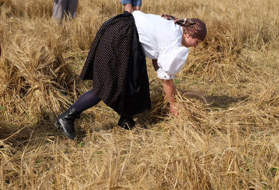 Rear view of man walking in farm