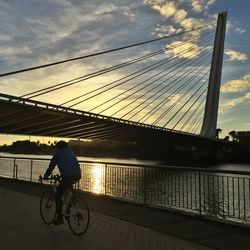 Man standing on bridge