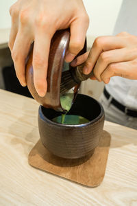 Close-up of woman hand on table