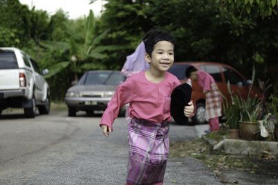 Full length of boy walking on road