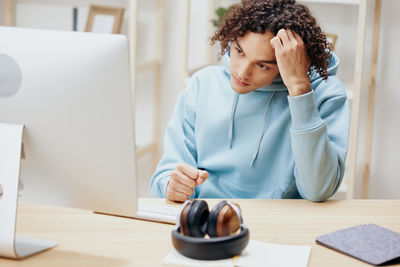 Young woman using laptop at table