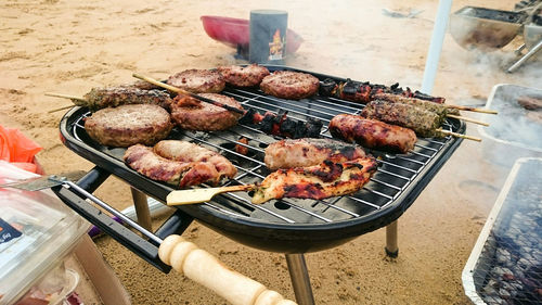 High angle view of meat on barbecue grill