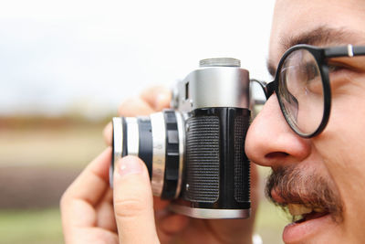 Cropped hand holding camera