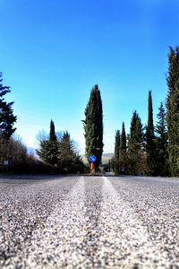 Surface level of road against blue sky