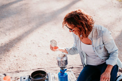 High angle view of woman holding drink