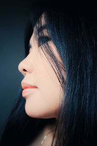 Close-up of beautiful young woman over white background