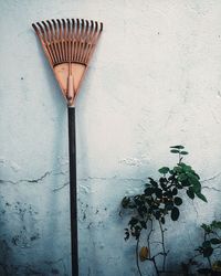 Rake against concrete wall 