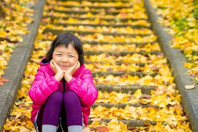 Portrait of a young woman standing in park