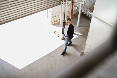 Bird's eye view of businesman walking at loading bay in a factory