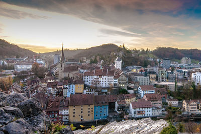 View of cityscape against cloudy sky