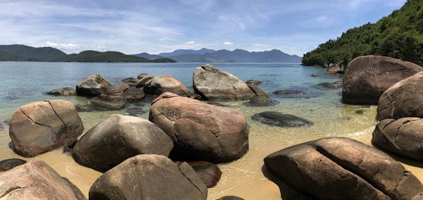 Rocks on sea shore against sky on ilha grande rio de janeiro 