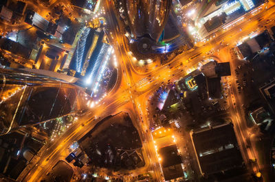 High angle view of city lit up at night