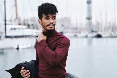 Portrait of young man sitting in boat