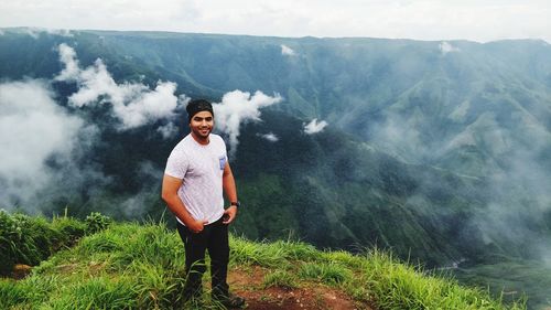 Full length of young man standing on mountain