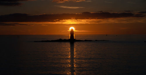 The lighthouse of the mangiabarche on a serene sunset,autumn day