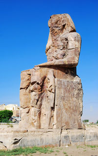 Low angle view of statue against clear blue sky