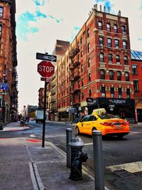 Street light by road against buildings in city