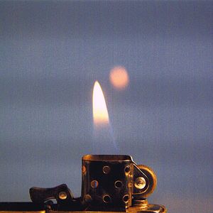 Close-up of illuminated lighting equipment against sky