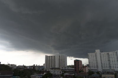 Buildings against cloudy sky