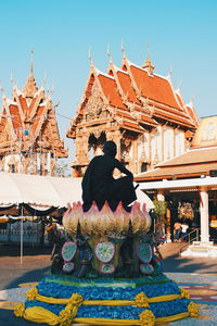 Rear view of statue against temple building