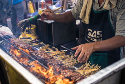 Man preparing food on barbecue grill