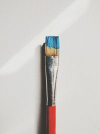 Close-up of paintbrush on white table