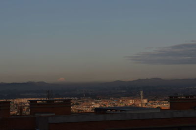 Cityscape with mountain range in background