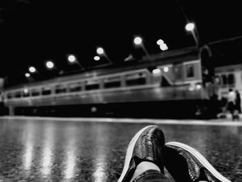 Low section of man at railroad station platform during night