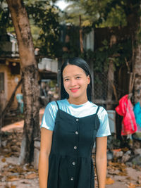 Portrait of young woman standing outdoors