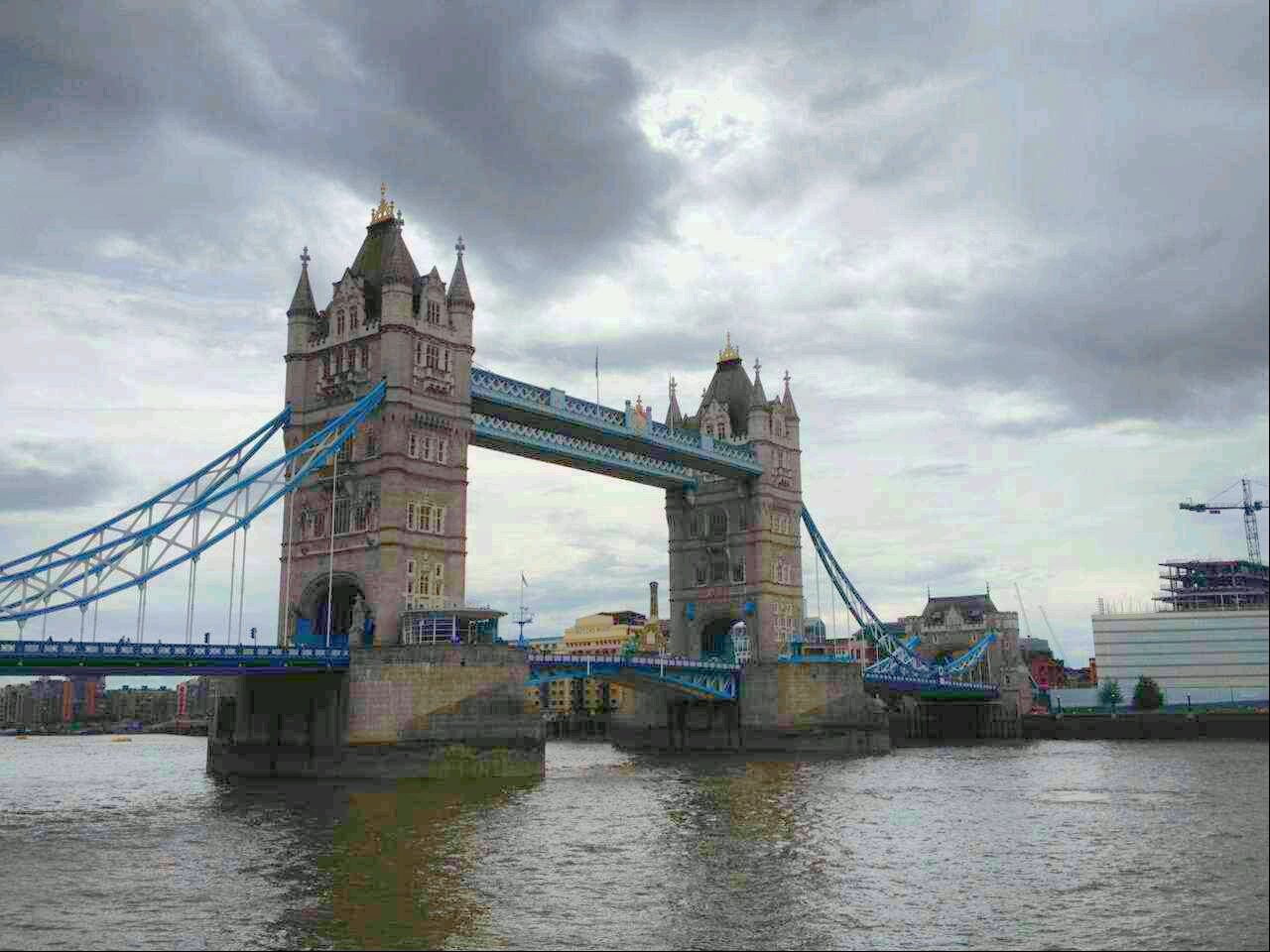 architecture, built structure, sky, connection, bridge - man made structure, cloud - sky, water, cloudy, transportation, waterfront, engineering, river, cloud, bridge, building exterior, low angle view, suspension bridge, outdoors, day, travel destinations