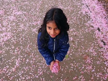 Portrait of girl with pink flower petals