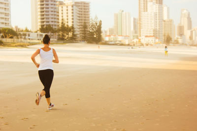 Full length of man on beach in city