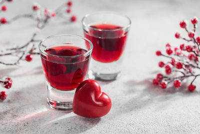 Red cocktail, vodka or liqueur and heart shape decorations