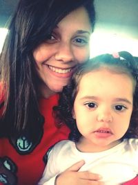 Portrait of happy mother and daughter at home