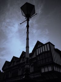 Low angle view of building against cloudy sky