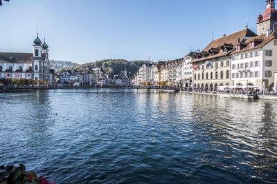 River amidst buildings against sky in city