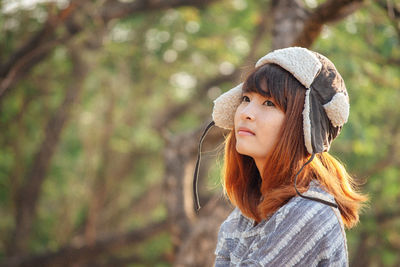 Portrait of young woman wearing hat