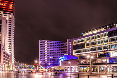 Illuminated buildings in city at night in berlin