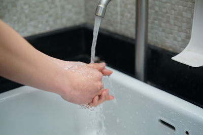 Midsection of man in bathroom at home