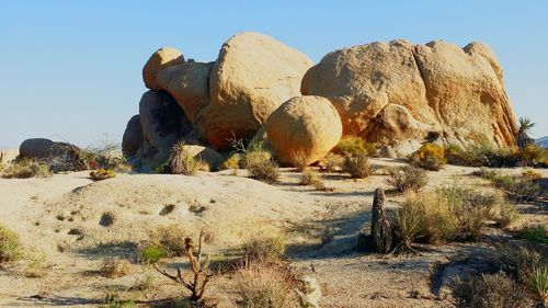 Panoramic view of rocks on land against clear sky