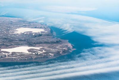 Aerial view of sea and mountains against sky