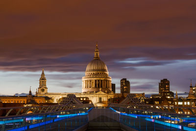 Illuminated building against sky at dusk